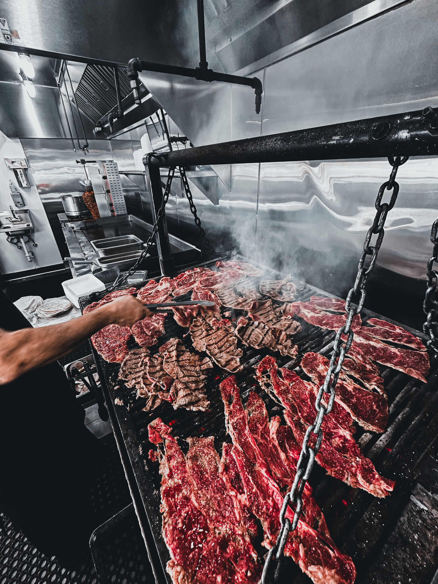 Carne asada grilling over mesquite charcoal
