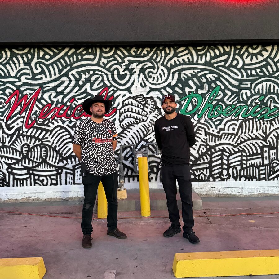 Taqueria Chicali team in front of the Puro Cachanilla mural